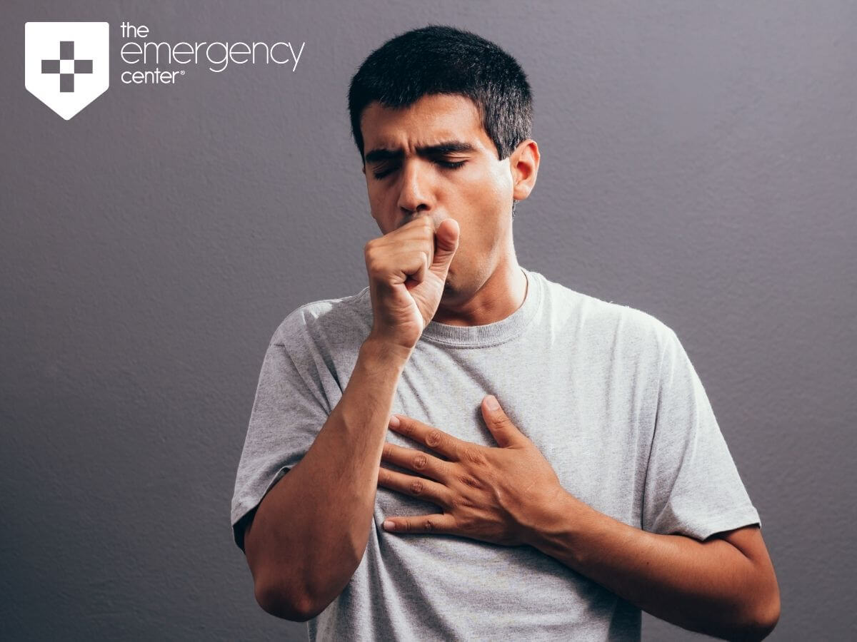 Man coughing, trying to win the battle against bronchitis with tips from the emergency center blog