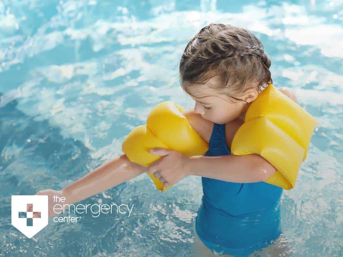 A girl putting on inflatable safety sleeves