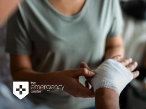 A clinician wrapping a gauze bandage around a patient's hand